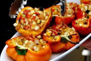 Vegetarian stuffed bell peppers under tomato sauce