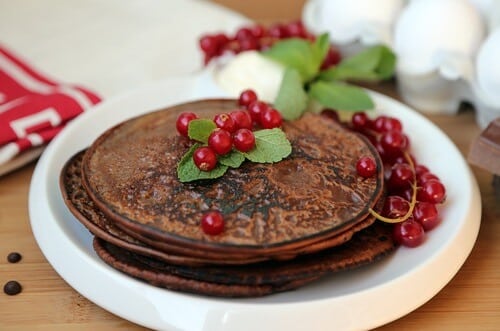 Chocolate pancakes with red currants