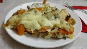 Roasted fish with mushrooms under cheese