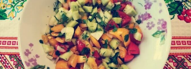 Red and yellow tomato, cucumber, and onion salad