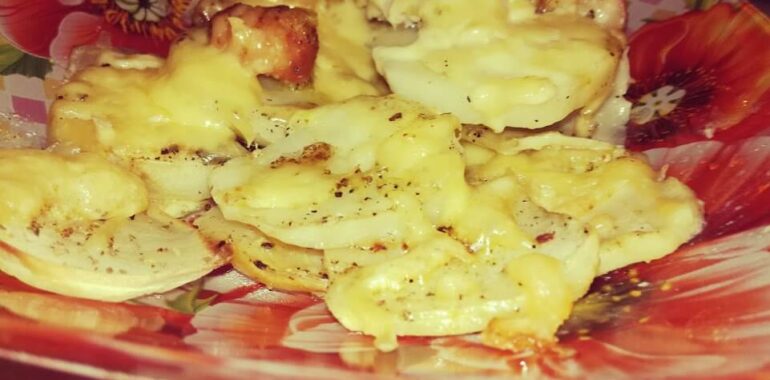 Baked chicken and potatoes with cheese