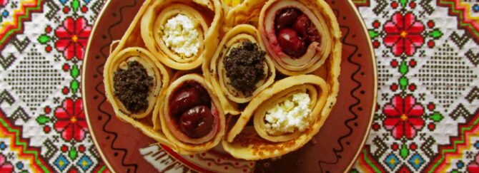 Rolled pancakes with poppy seeds, sour cherries, and cottage cheese