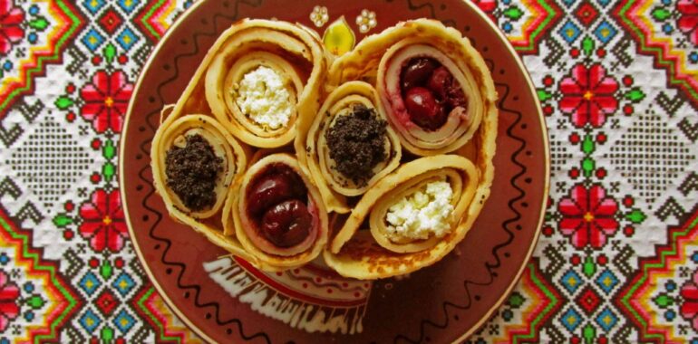 Rolled pancakes with poppy seeds, sour cherries, and cottage cheese